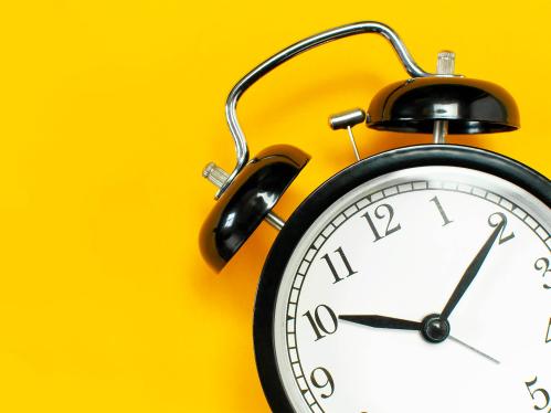 alarm clock on a yellow backgroun