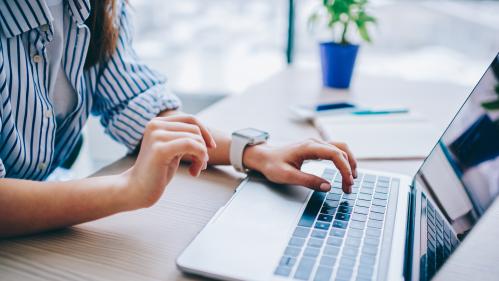 Stock Photo of a person typing on a laptop
