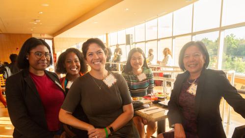 Julia Baumanis, Marjoris Regus, Shelly Zhand, Nancy Yunhwa Rao, and another woman standing by a table 