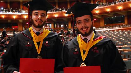 Brothers Adam and Joe Kabakibi stand together as University-Newark's School of Arts and Sciences-Newark at commencement