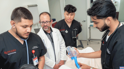 a doctor and three male nurses in a training class