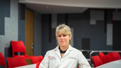 Antonina Mitrofanova wearing a white lab coat in a classroom