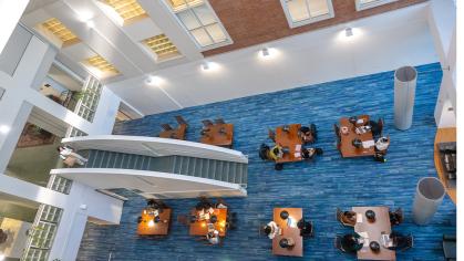 students sitting at tables in the Alexander Library on the College Avenue Campus