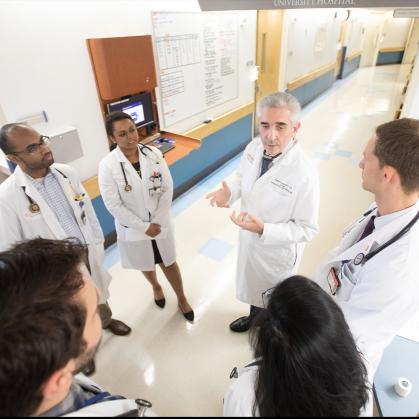 four medical students listening to a doctor