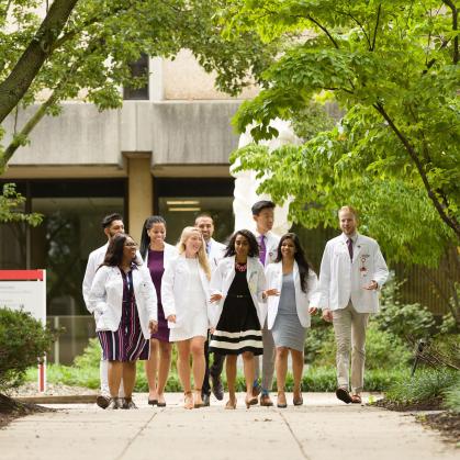 a group of menical students walking on campus