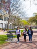 three ladies walking on campus