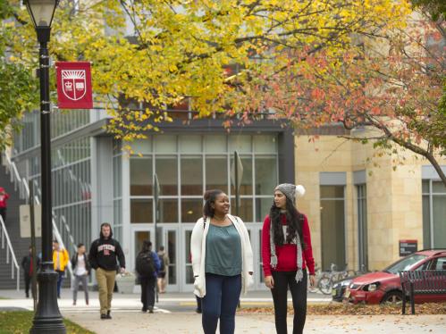 two students walk through campus