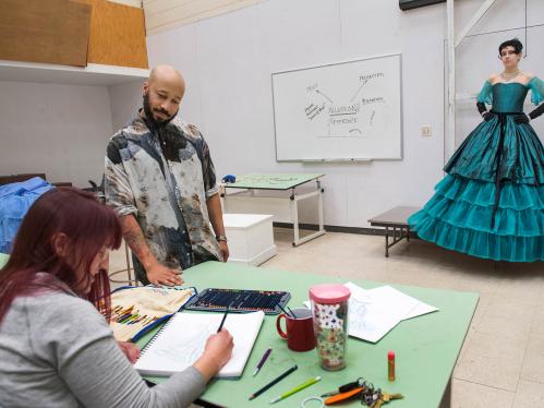 Guest Lecturer of Costume Design Shane Ballard works with a student