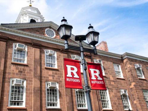 Old Queens building with the Rutgers flags on the lamppost