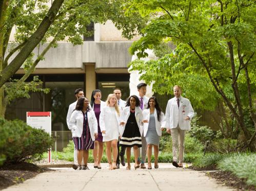 a group of menical students walking on campus