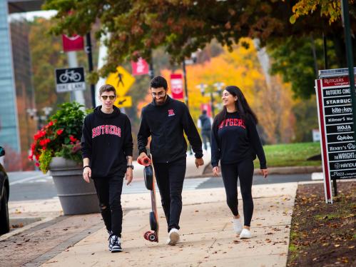 Three students walking on the Livingston campus