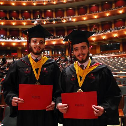 Brothers Adam and Joe Kabakibi stand together as University-Newark's School of Arts and Sciences-Newark at commencement