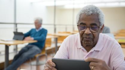 African American male holding an ipad