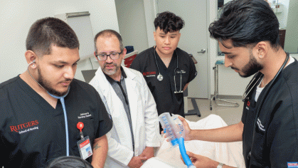 a doctor and three male nurses in a training class
