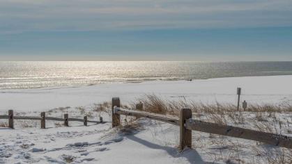 sandy beach with the ocean in the distance