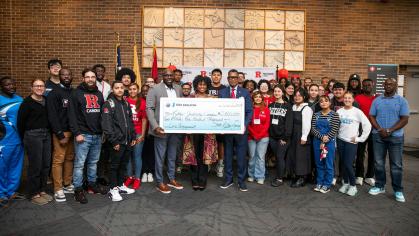 New Jersey State Sen. Troy Singleton presents a check to Rutgers University–Camden