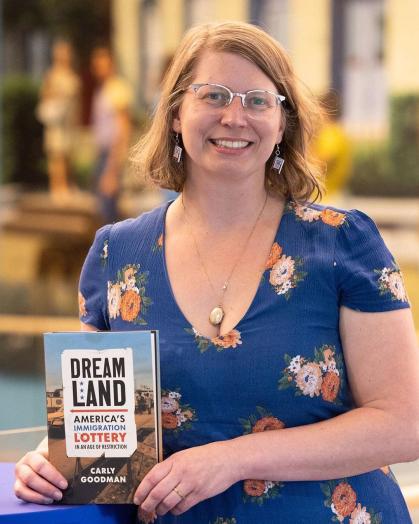 Carly Goodman holding her book Dreamland: America’s Immigration Lottery in an Age of Restriction
