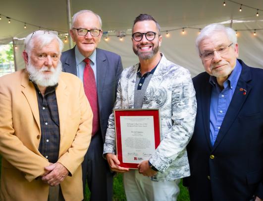 Kevin Emmons, School of Nursing–Camden holding award with three other gentlemen